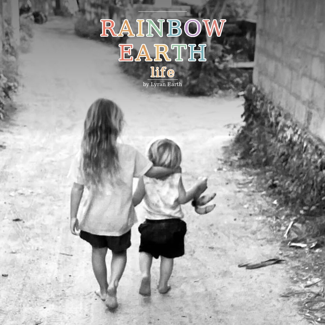 Two sisters walking hand in hand down a dirt path, with the Rainbow Earth Life by Lyran Earth wordmark overlaid